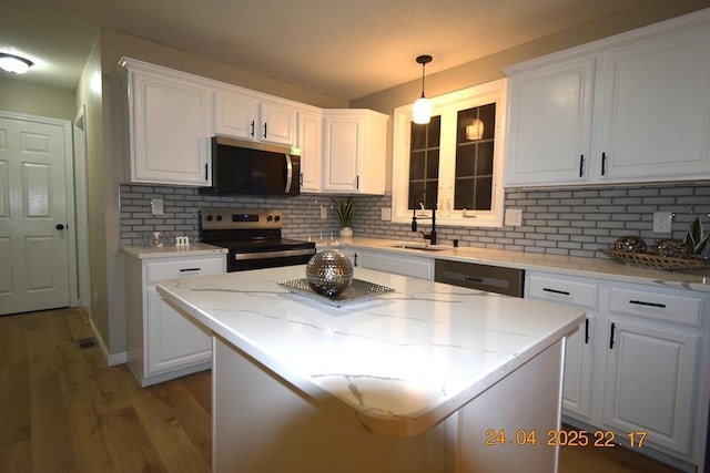kitchen with white cabinets, stainless steel appliances, and a sink