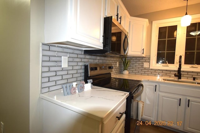 kitchen with a sink, electric stove, decorative backsplash, and white cabinetry