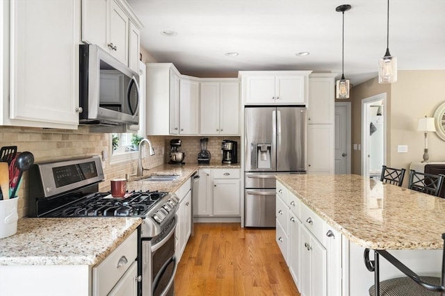 53 Gilbert Rd, Southampton, MA 01073 - kitchen with appliances with stainless steel finishes, a sink, light wood-style floors, white cabinetry, and recessed lighting