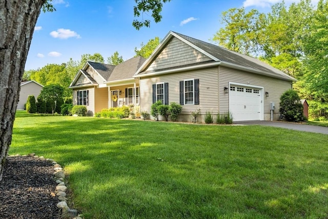 53 Gilbert Rd, Southampton, MA 01073 - view of front facade with asphalt driveway, an attached garage, and a front lawn