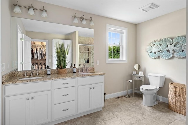 53 Gilbert Rd, Southampton, MA 01073 - full bathroom with baseboards, a stall shower, double vanity, and toilet