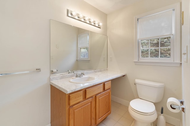 bathroom featuring tile patterned flooring, vanity, and toilet