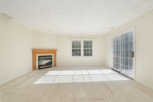 unfurnished living room featuring light colored carpet