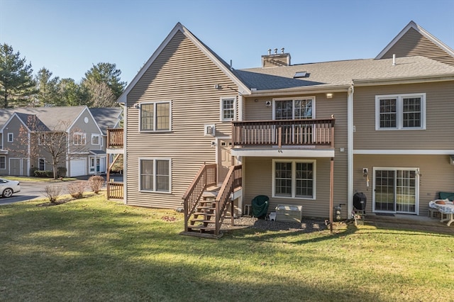 rear view of property featuring a balcony and a yard