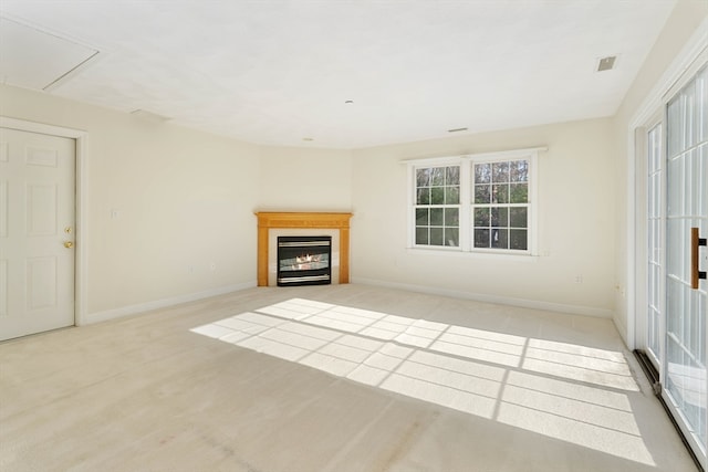 unfurnished living room featuring light colored carpet