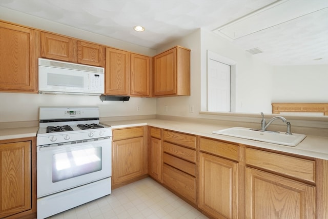 kitchen featuring white appliances and sink