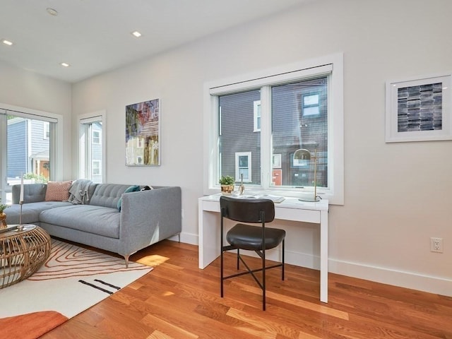 living room with recessed lighting, wood finished floors, and baseboards