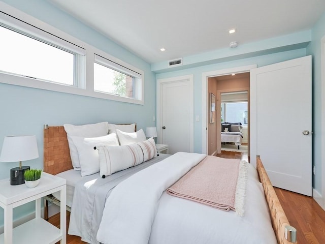 bedroom featuring recessed lighting, visible vents, and wood finished floors