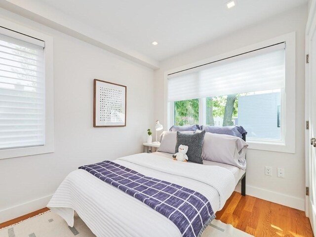 bedroom with recessed lighting, light wood-type flooring, and baseboards