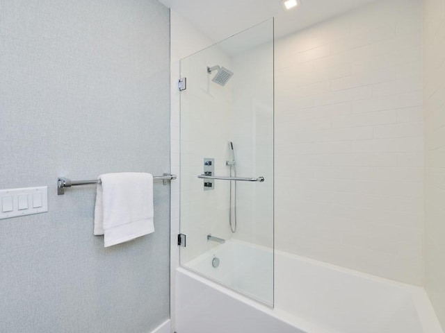 bathroom featuring bath / shower combo with glass door