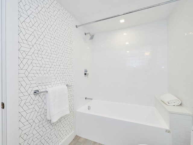 bathroom featuring shower / tub combination and wood finished floors