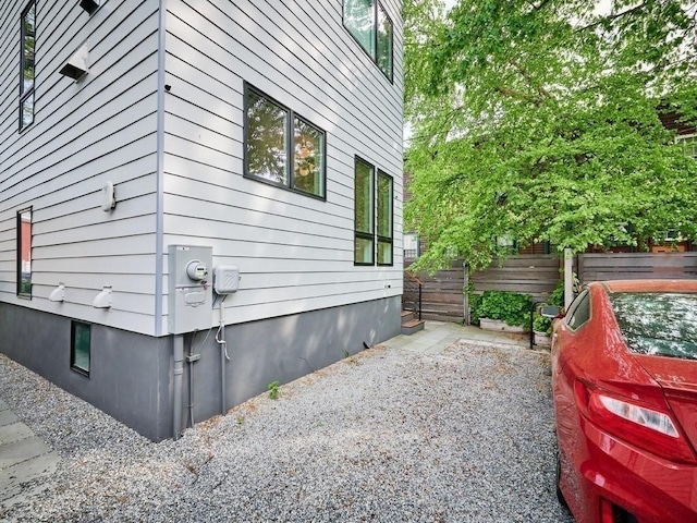 view of side of home featuring fence