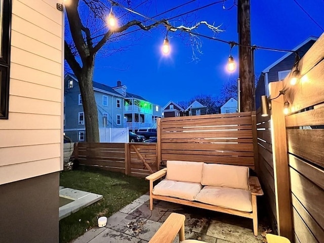 view of yard with a residential view, fence, and an outdoor living space