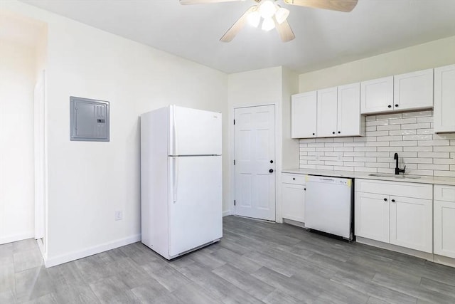 kitchen with white cabinetry, sink, electric panel, white appliances, and light wood-type flooring