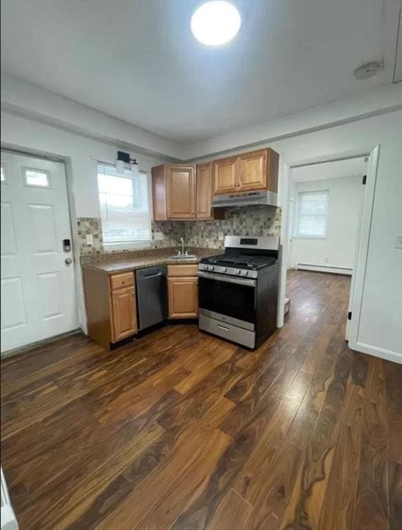 kitchen with plenty of natural light, dishwasher, dark wood-type flooring, and stainless steel range oven