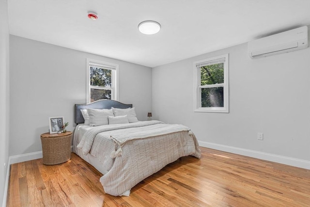 46 Curtis St, Brockton, MA 02301 - bedroom featuring a wall mounted AC, multiple windows, and light wood-style floors