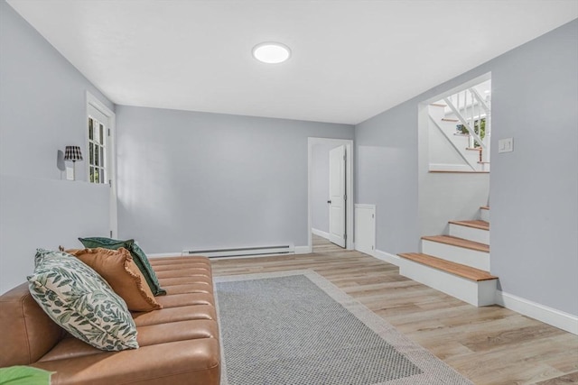 46 Curtis St, Brockton, MA 02301 - living area featuring a baseboard heating unit, wood finished floors, and stairway