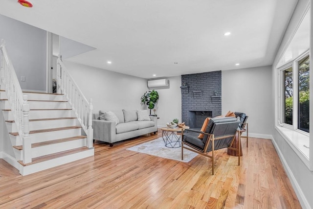 46 Curtis St, Brockton, MA 02301 - living room with a wall mounted air conditioner, stairway, light wood-type flooring, a brick fireplace, and recessed lighting