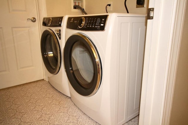 clothes washing area featuring separate washer and dryer