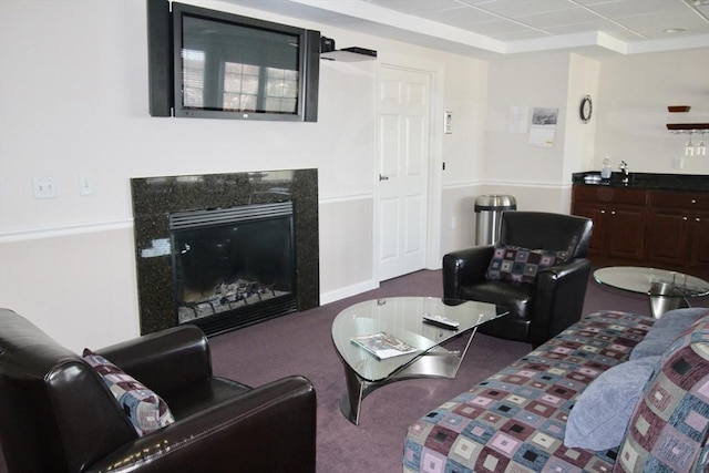 carpeted living room with a premium fireplace