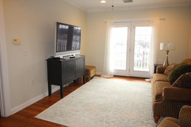 doorway with dark hardwood / wood-style floors, ceiling fan, and ornamental molding