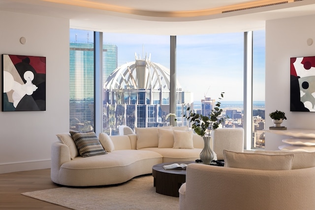 living room featuring floor to ceiling windows and hardwood / wood-style floors