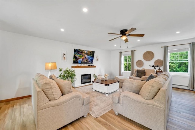 182 Sheldon Rd, Fitchburg, MA 01420 - living area featuring ceiling fan, recessed lighting, a glass covered fireplace, light wood finished floors, and baseboard heating