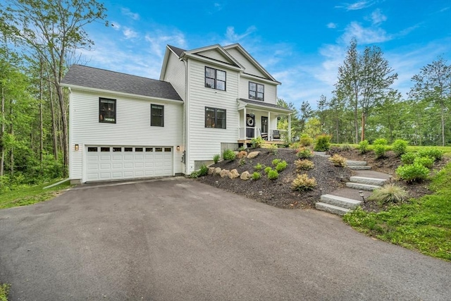 182 Sheldon Rd, Fitchburg, MA 01420 - traditional-style house with a garage, driveway, and covered porch