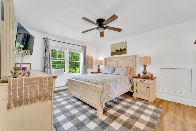 182 Sheldon Rd, Fitchburg, MA 01420 - bedroom featuring light wood-style floors, a baseboard radiator, ceiling fan, and cooling unit