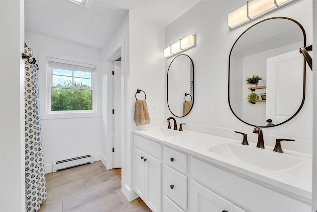 182 Sheldon Rd, Fitchburg, MA 01420 - bathroom featuring baseboard heating, double vanity, and a shower