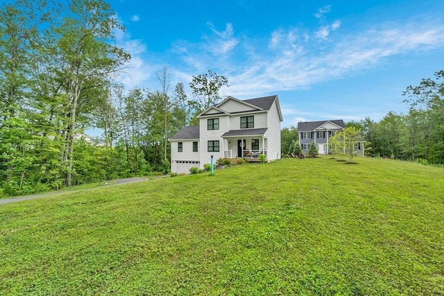 182 Sheldon Rd, Fitchburg, MA 01420 - traditional-style house featuring a front lawn, driveway, a garage, and roof with shingles