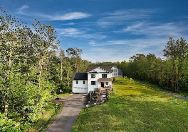 182 Sheldon Rd, Fitchburg, MA 01420 - traditional-style house featuring asphalt driveway, a front lawn, and a view of trees
