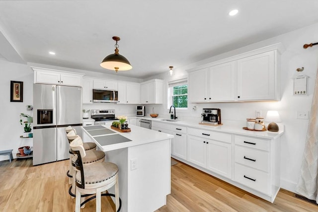 182 Sheldon Rd, Fitchburg, MA 01420 - kitchen with appliances with stainless steel finishes, white cabinets, a center island, and recessed lighting