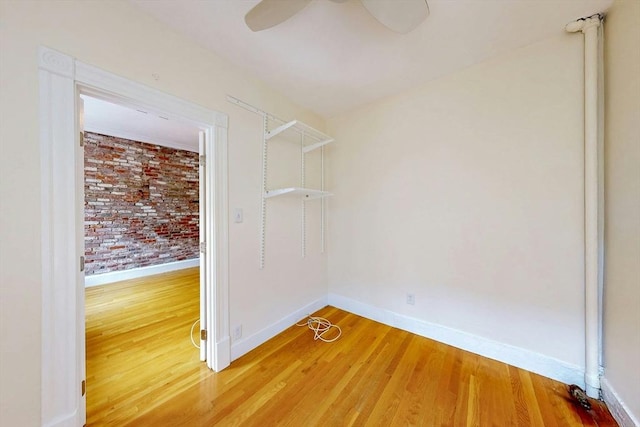 11 Irving St Unit 4, Boston, MA 02114 - spare room with brick wall, baseboards, light wood-type flooring, and a ceiling fan