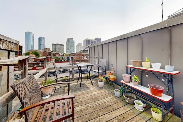 11 Irving St Unit 4, Boston, MA 02114 - wooden deck with a skyline view and outdoor dining space