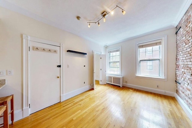 11 Irving St Unit 4, Boston, MA 02114 - unfurnished bedroom with radiator heating unit, light wood-type flooring, ornamental molding, and baseboards