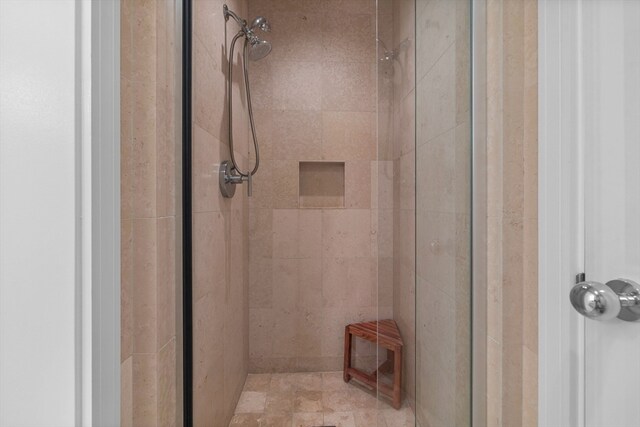 bathroom featuring a shower with shower door