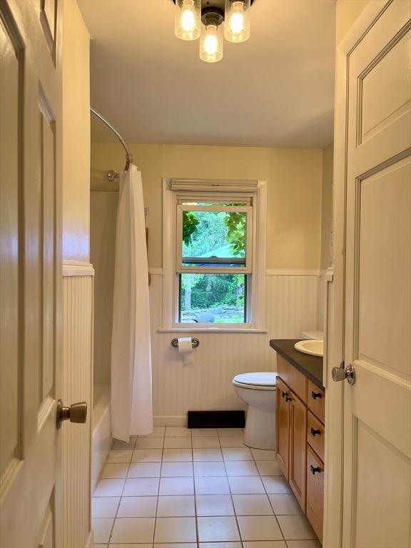 947 Burts Pit Rd, Northampton, MA 01062 - bathroom featuring a wainscoted wall, vanity, tile patterned flooring, a chandelier, and shower / bath combo