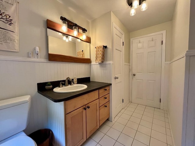 947 Burts Pit Rd, Northampton, MA 01062 - bathroom with tile patterned flooring, a wainscoted wall, and vanity