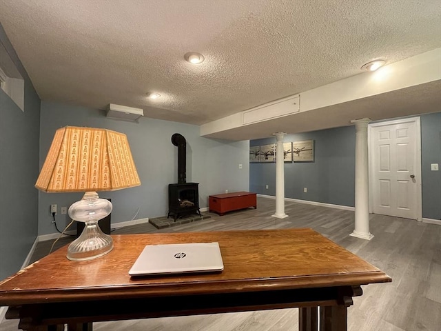 947 Burts Pit Rd, Northampton, MA 01062 - living area with a textured ceiling, wood finished floors, a wood stove, and decorative columns