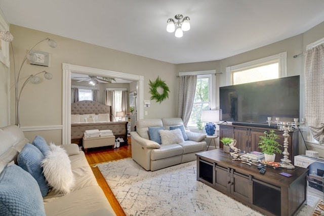 living room with hardwood / wood-style floors and ceiling fan