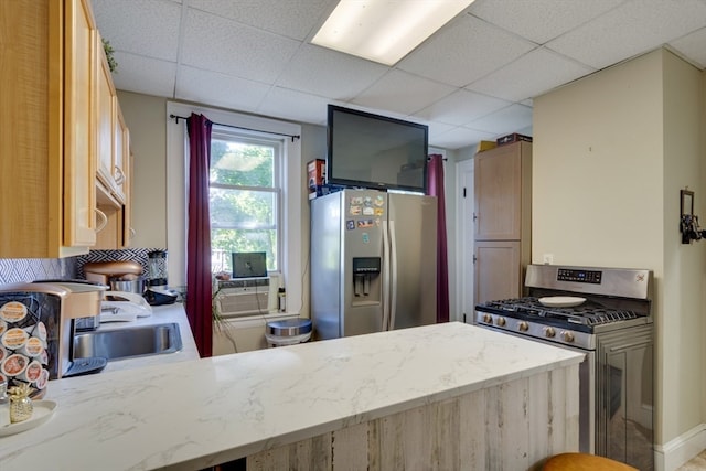 kitchen featuring cooling unit, light brown cabinets, kitchen peninsula, a paneled ceiling, and stainless steel appliances