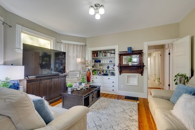 living room featuring cooling unit and light hardwood / wood-style flooring