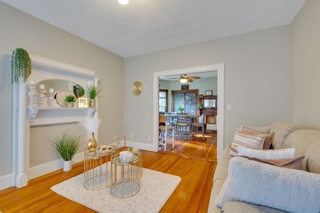 living room with hardwood / wood-style flooring and ceiling fan