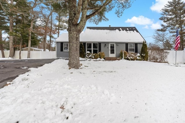 view of snow covered rear of property