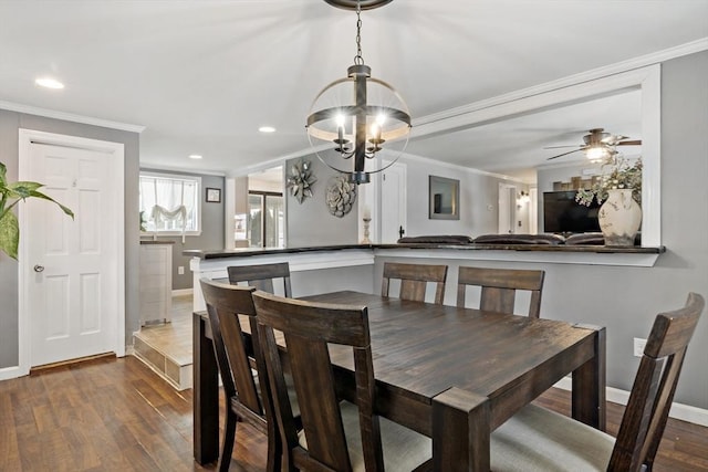 dining space with crown molding, dark wood-type flooring, and ceiling fan with notable chandelier