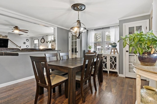 dining room featuring ceiling fan with notable chandelier, ornamental molding, and dark hardwood / wood-style floors