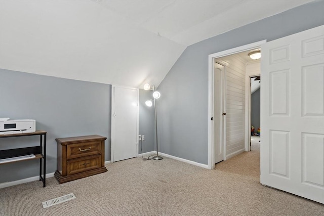 carpeted bedroom featuring lofted ceiling