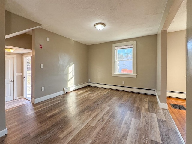 unfurnished room featuring hardwood / wood-style flooring and a textured ceiling