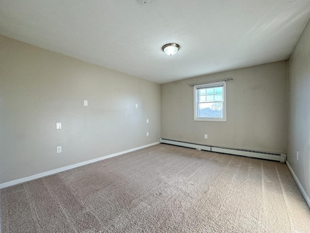 spare room featuring a baseboard radiator and carpet floors